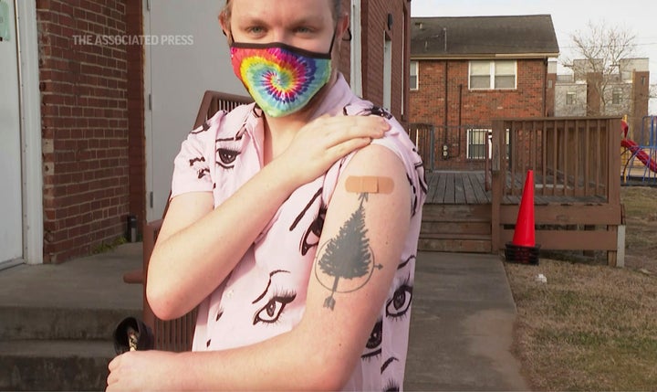 In this image from video, Jesse Robinson shows the spot on his arm where he received his COVID-19 vaccination, in Nashville,