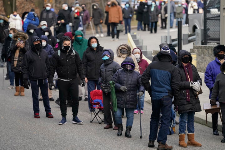 People wait in line for the COVID-19 vaccine in Paterson, N.J., on Jan. 21, 2021. The first people arrived around 2:30 a.m. for the chance to be vaccinated at one of the few sites that does not require an appointment. 