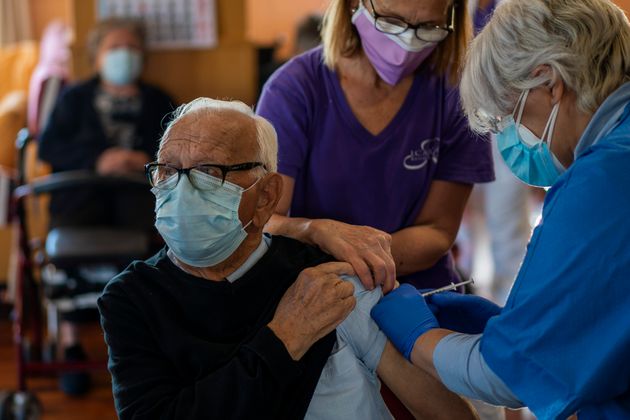 Un résident de maison de retraite se fait vacciner contre le Covid-19 à Barcelone.  (AP Photo/Emilio Morenatti)