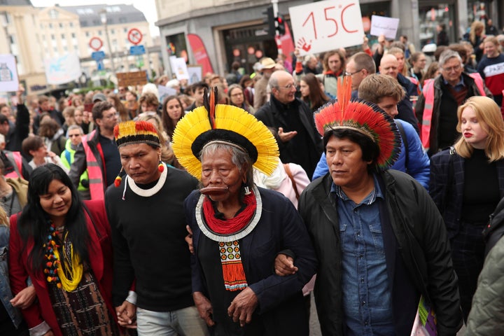 Chief Raoni Metuktire, center front, takes part in a climate march in Brussels on May 17, 2019. The activist has become a symbol of the fight for Indigenous rights and preservation of the Amazon rainforest. 