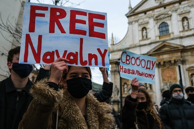 Supporters of the Russian opposition leader, Alexei Navalny hold banners and shout slogans during a protest against his arrest. 