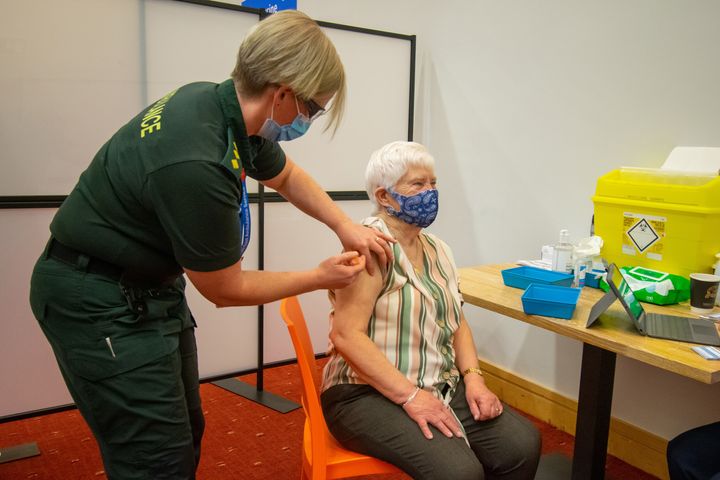 An elderly woman receives an injection of a Covid-19 vaccine at a NHS vaccination centre that has been set up at the Life Science Centre.