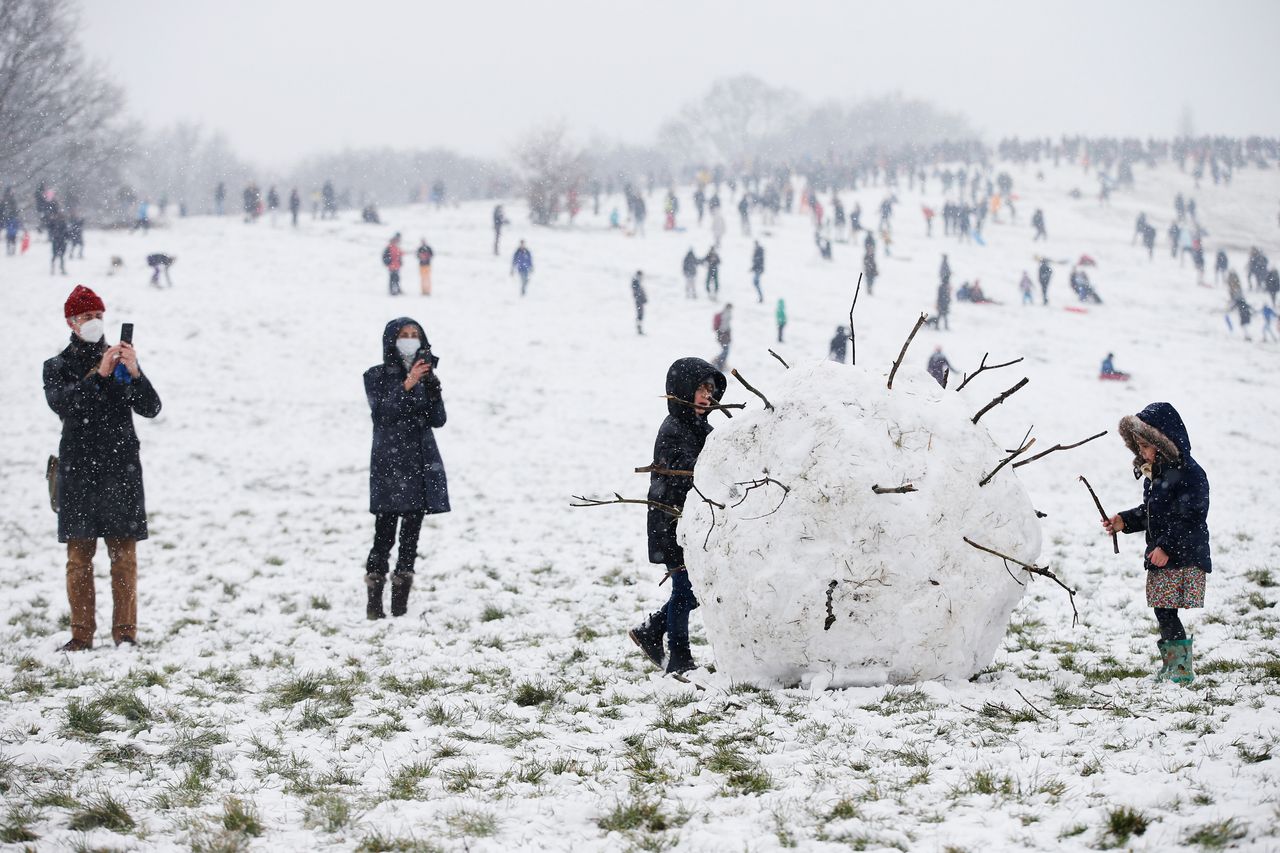 A giant snowball shaped as a coronavirus is seen on Parliament Hill on Hampstead Heath in London, United Kingdom. 