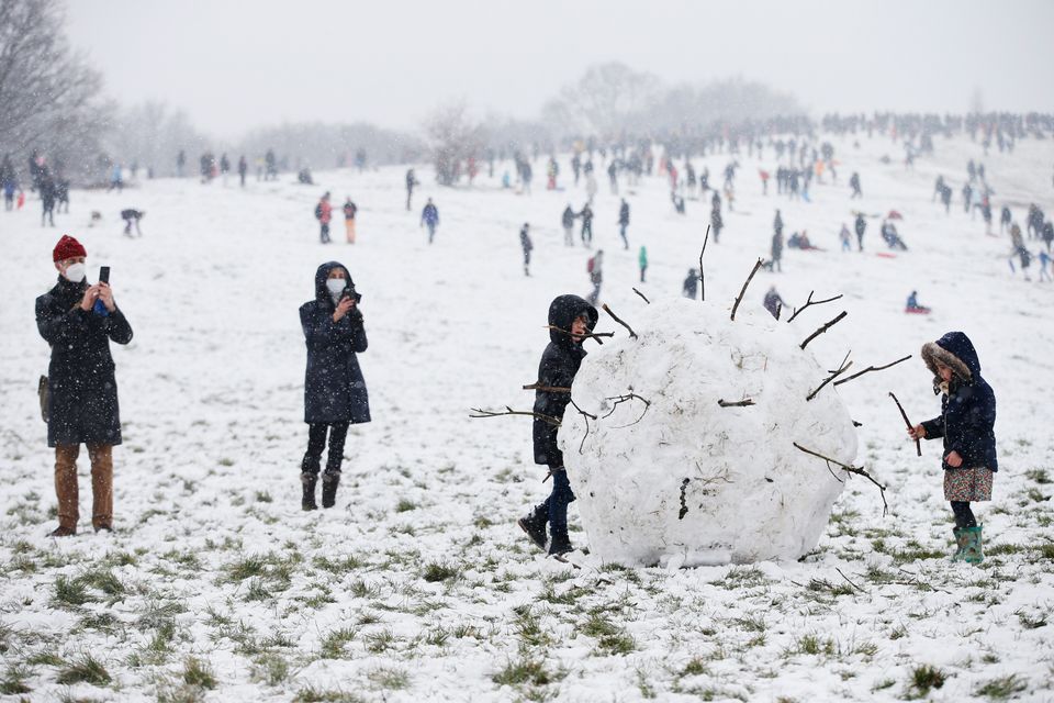 A giant snowball shaped as a coronavirus is seen on Parliament Hill on Hampstead Heath in London, United Kingdom. 