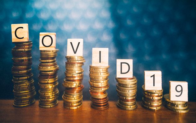 Diminishing stacks of coins with COVID-19 (Coronavirus disease) written on