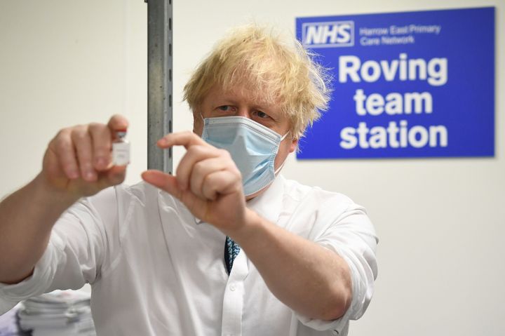 Boris Johnson holds a vial of the Oxford/AstraZeneca Covid-19 vaccine.