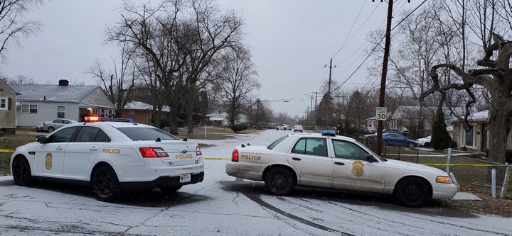 Indianapolis Metropolitan Police Department work the scene Sunday after five people, including a pregnant woman, were shot to