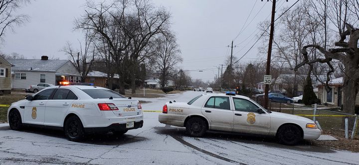 Indianapolis Metropolitan Police Department work the scene Sunday after five people, including a pregnant woman, were shot to death inside an Indianapolis home.