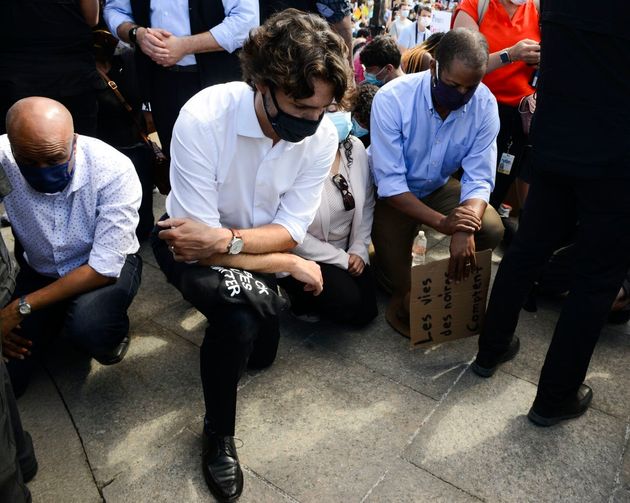 Trudeau takes a knee as he takes part in an anti-racism protest on Parliament Hill in June