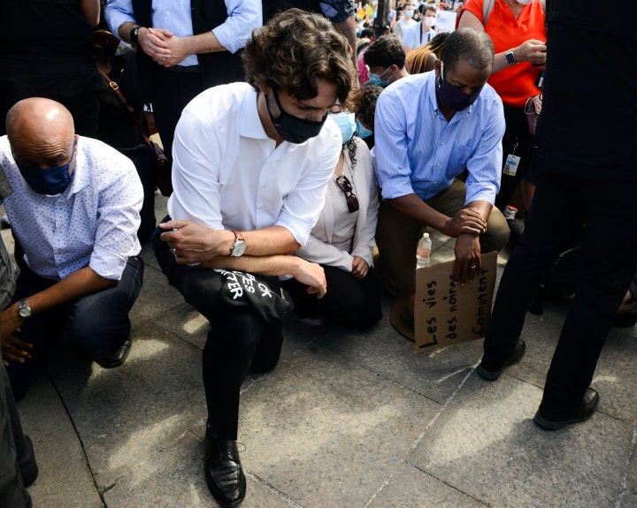 Trudeau takes a knee as he takes part in an anti-racism protest on Parliament Hill in June 2020.