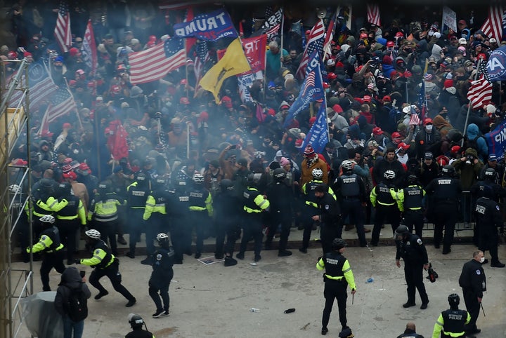 Rioters incited to attack the U.S. Capitol by Donald Trump to disrupt the counting of the electoral college votes clash with
