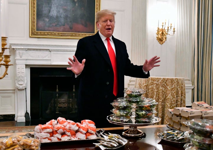 Then-President Donald Trump with a bunch of fast food in January 2019. Trump wanted to make poultry lines run faster even though workers were getting sick with COVID-19.