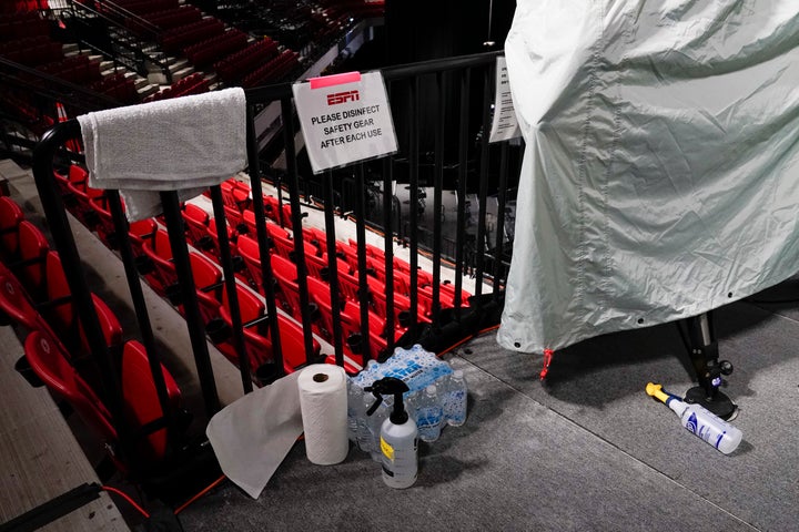 Disinfectant spray sits near television cameras inside a basketball arena at ESPN Wide World of Sports Complex Wednesday, July 29, 2020, in Orlando, Florida. 