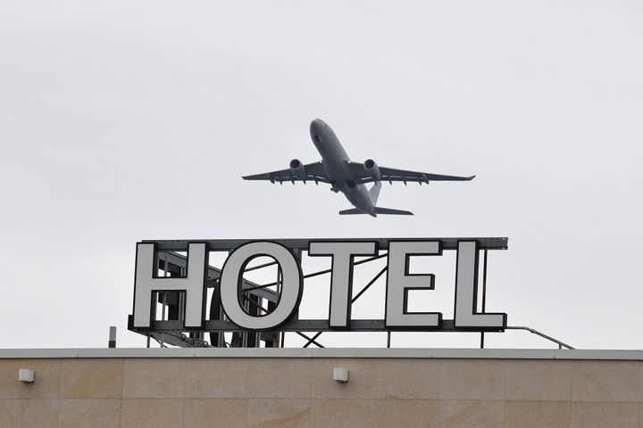 An airplane is seen flying over a hotel at Heathrow Airport in west London.