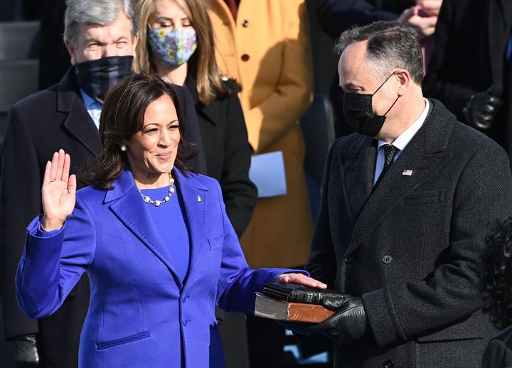Kamala Harris, flanked by her husband Doug Emhoff, is sworn in as the vice president of the United States on Jan. 20.