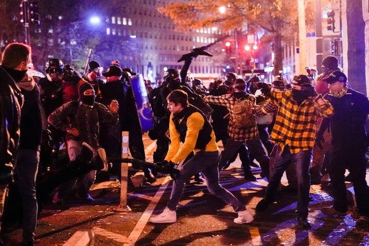 Members of the far-right group Proud Boys clash with counter protesters in downtown Washington.