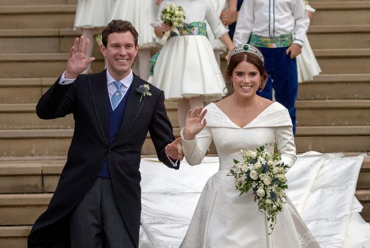 Princess Eugenie of York and her husband, Jack Brooksbank, wave as they emerge from St. George's Chapel at Windsor Castle on their wedding day in 2018. The two have welcomed their first child.