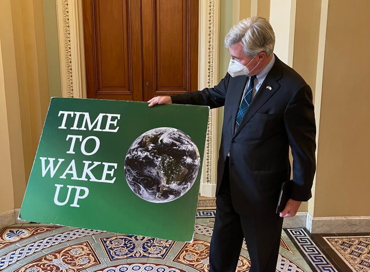 “Hope to God I won’t need to bring it back out," Sen. Sheldon Whitehouse said of his "Time To Wake Up" sign.