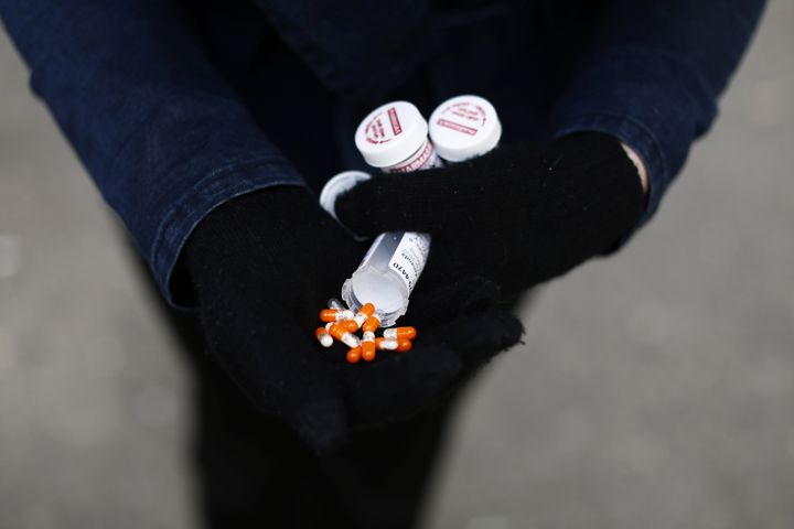 A fentanyl user displays a "safe supply" of opioid alternatives, including morphine pills, provided by the local health unit to combat overdoses due to poisonous additives in the Downtown Eastside of Vancouver on April 6, 2020.