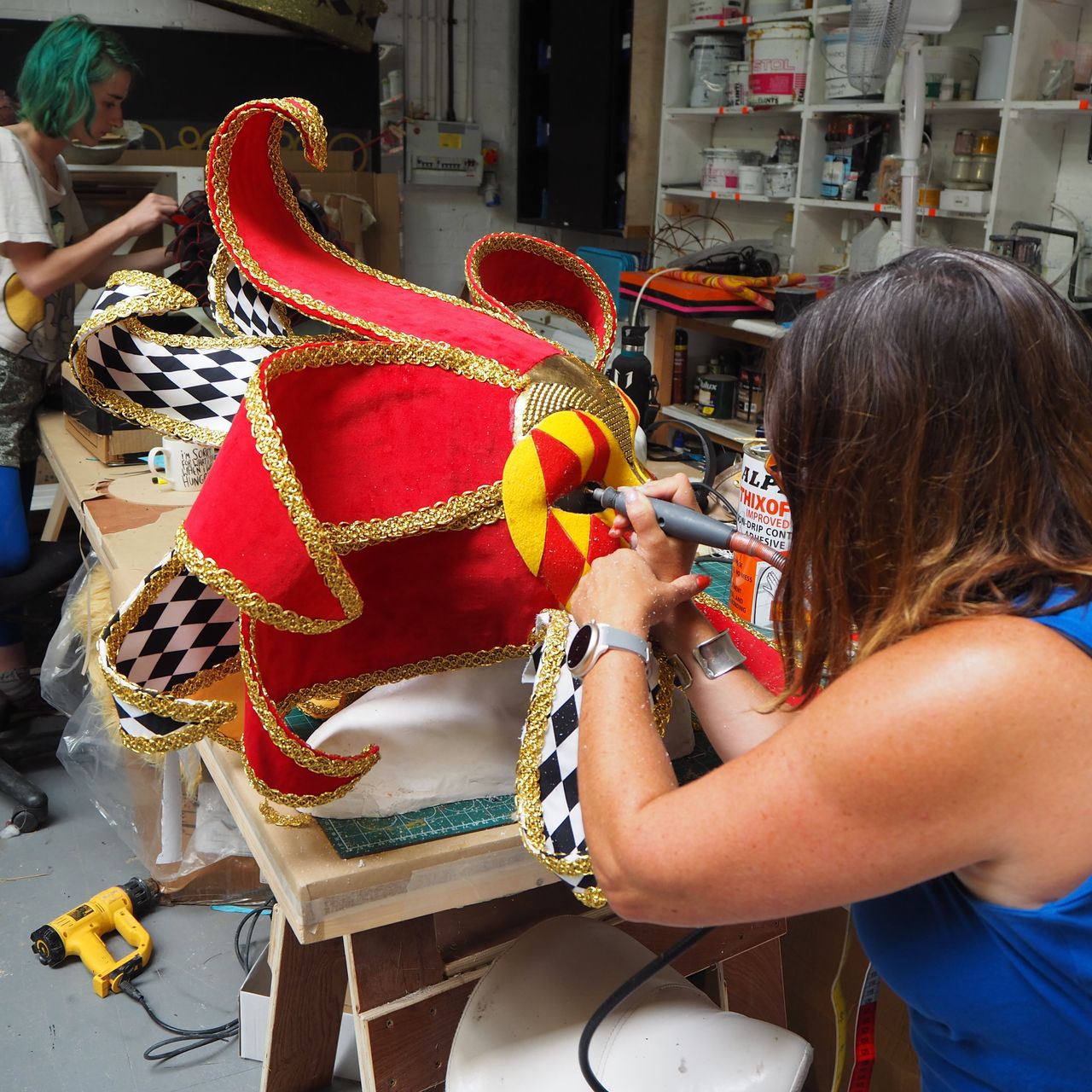 Work is done on Harlequin's Venetian-inspired mask