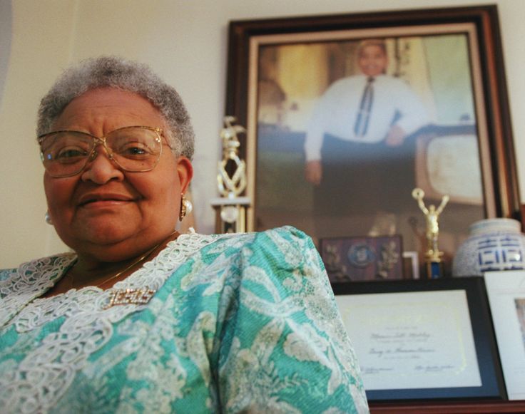 Mamie Till-Mobley, who died in 2003, poses before a portrait of her slain son.