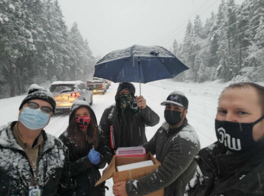 Josephine County Public Health workers walked between cars on Tuesday to administer COVID-19 vaccinations in a snowstorm