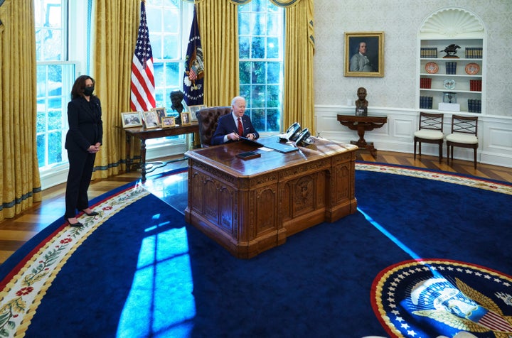 President Joe Biden, with Vice President Kamala Harris, signs executive orders on health care in the Oval Office on Thursday.