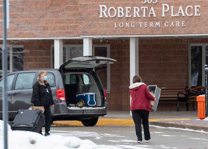 Workers arrive at the Roberta Place Long Term Care in Barrie, Ont. on Jan. 18, 2021.