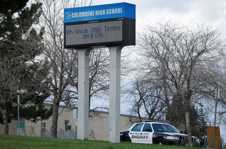 In this April 17, 2019, file photo, a patrol car is parked in front of Columbine High School in Littleton, Colorado, where tw