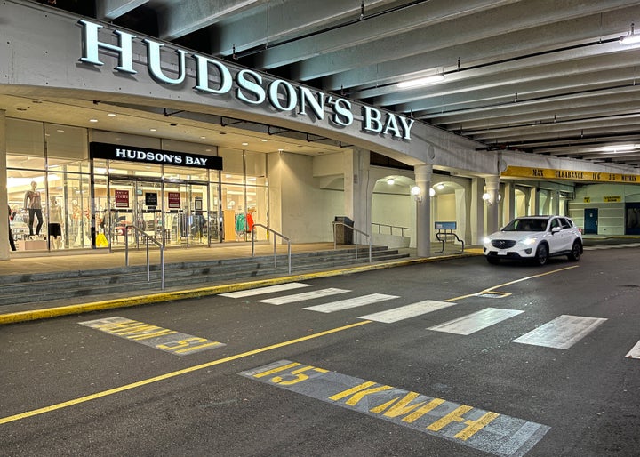 A vehicle passes the storefront of a Hudson's Bay department store on Nov. 22, 2020 in Richmond, B.C.