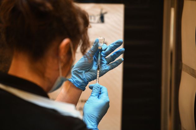 A healthcare professional draws up a dose of Covid-19 vaccine to be administered at a vaccination centre.