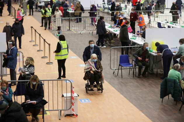 People receive the COVID-19 vaccine at the Derby Arena velodrome in Derby, Derbyshire, Britain, January...