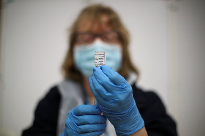 A healthcare worker prepares a dose of the Covid vaccine in Derby.