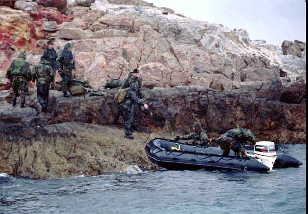 A Turkish SWAT team prepares to leave one of the controversial Kardak (Imia) islets after Greek troops were withdrawn from another one of the islets early Wednesday morning, Jan. 31, 1996. The Turkish commandos landed on the islet with a swift and quiet midnight operation, but didn't have to stay for long. The United States intervened to end the three-day crisis between Turkey and Greece because of claims by both on the uninhabited islets in the Aegean. (AP Photo/Hurriyet)