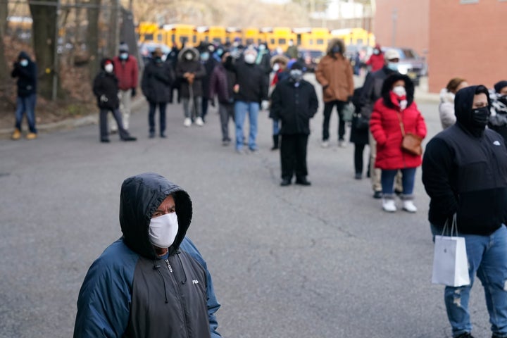 People wait in line for the COVID-19 vaccine in Paterson, N.J., Thursday, Jan. 21, 2021. Some hospitals around the U.S. are facing complaints about favoritism and line-jumping after their board members and donors received COVID-19 vaccinations or offers for the prized inoculations. (AP Photo/Seth Wenig)