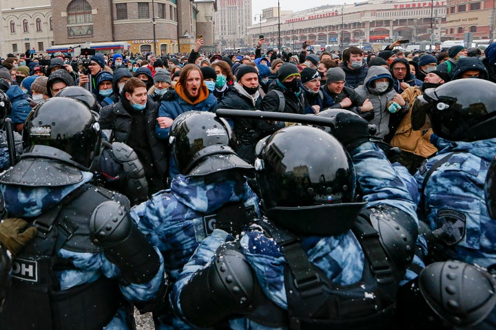 People clash with police during a protest against the jailing of opposition leader Alexei Navalny in Moscow, Russia, Sunday,