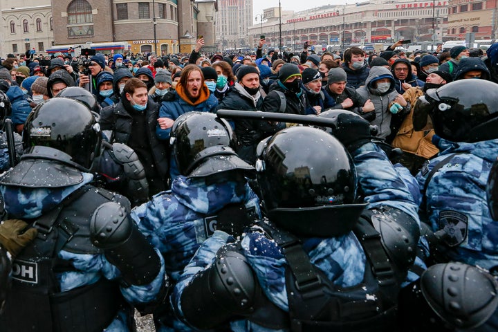 People clash with police during a protest against the jailing of opposition leader Alexei Navalny in Moscow, Russia, Sunday, Jan. 31, 2021. Thousands of people took to the streets Sunday across Russia to demand the release of jailed opposition leader Alexei Navalny, keeping up the wave of nationwide protests that have rattled the Kremlin. Hundreds were detained by police. (AP Photo/Alexander Zemlianichenko)