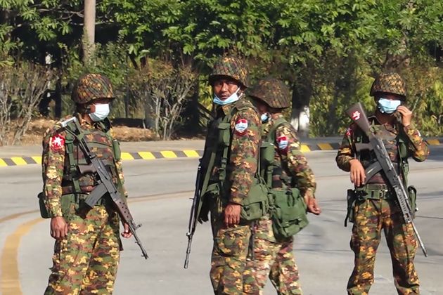 Soldiers stand guard on a street in Naypyidaw on February 1, 2021, after the military detained the country's de facto leader Aung San Suu Kyi.