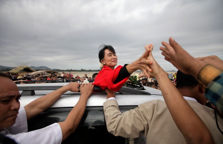 Myanmar pro-democracy leader Aung San Suu Kyi shakes hands with supporters after giving a speech in Monywa in 2012.