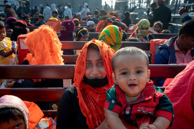 A Rohingya refugee woman with her son sits on a Bangladesh navy vessel will move to the Bhasan Char island in Noakhali district, Bangladesh last year.