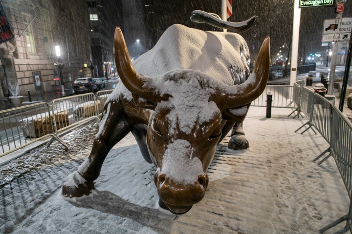 The bull of Wall Street is seen during the snowstorm that began on Sunday in New York City. New York City Mayor Bill de Blasio has declared a state of emergency.