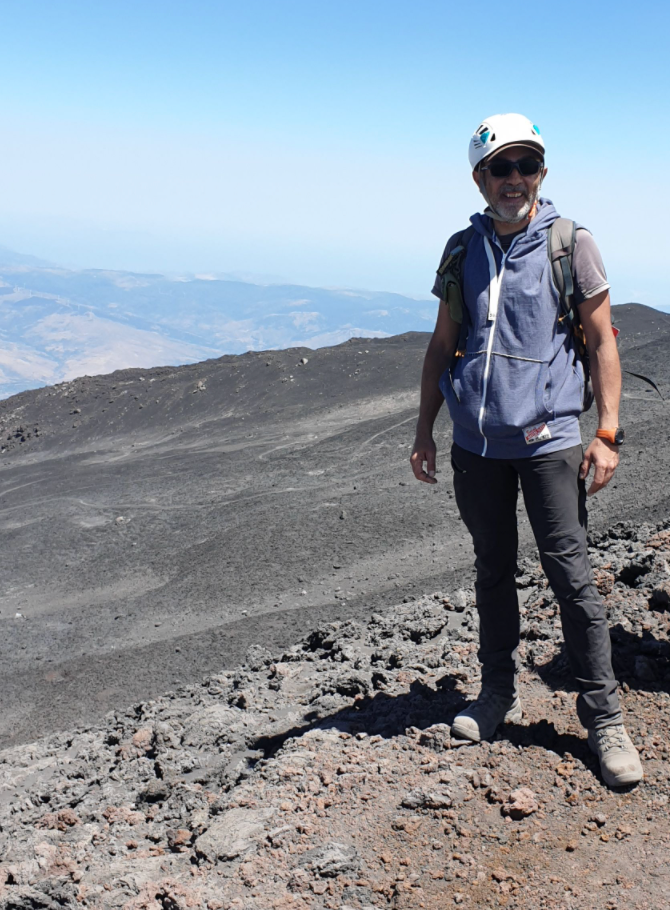 Gianpaolo standing with the lava flow behind him