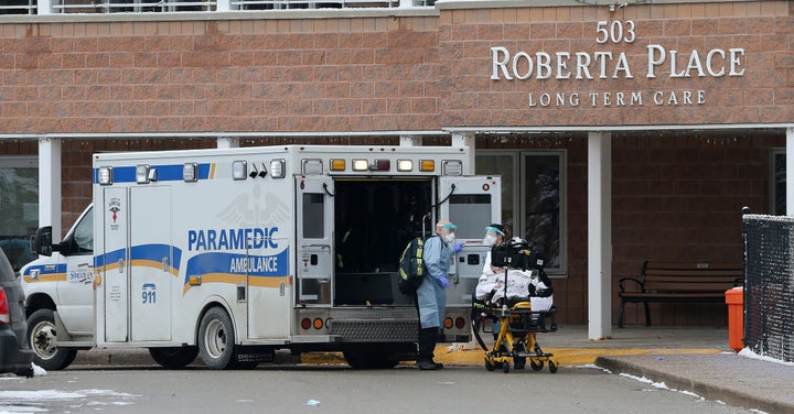 An ambulance loads a patient from Roberta Place in Barrie, Ont., on Jan. 18, 2021.