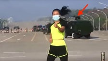 Woman Calmly Teaches Aerobics Class As Military Coup Unfolds Behind Her Woman Calmly Teaches Aerobics Class As Military Coup Unfolds Behind Her