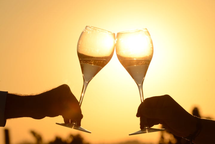 toasting with sparkling wine at sunset