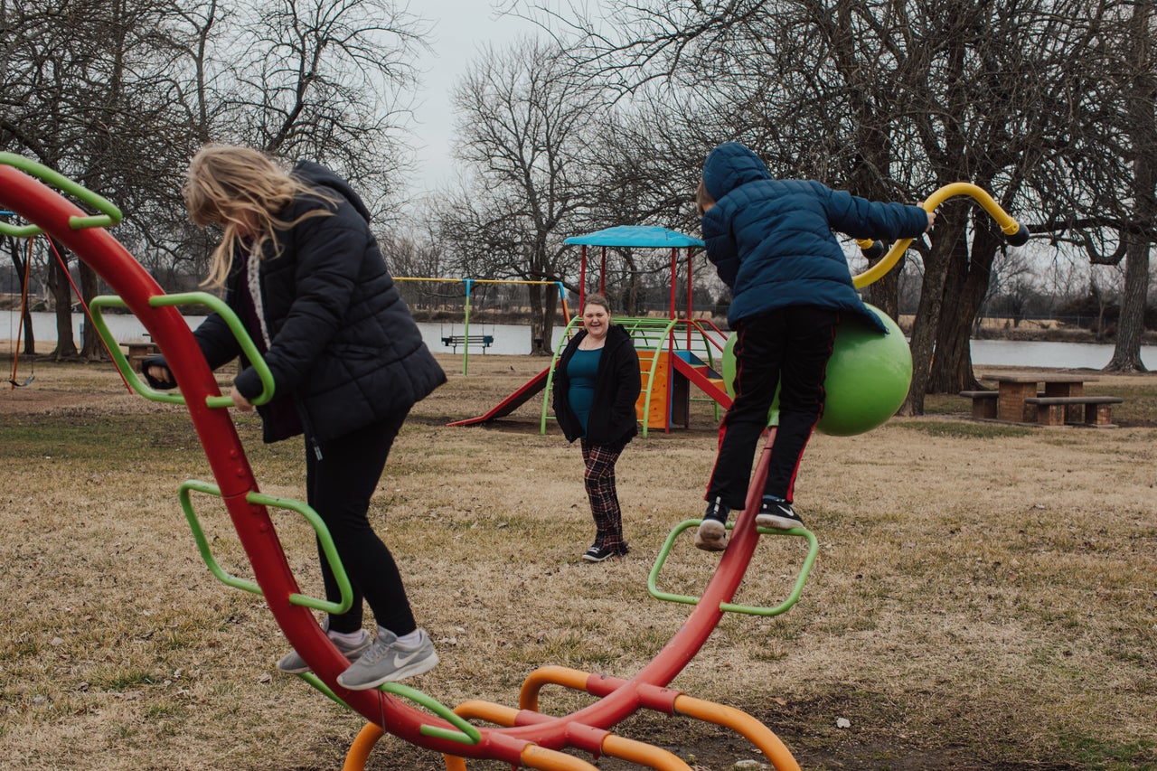 Tami Burch watches as her kids Mia and Jesse play at a park. 