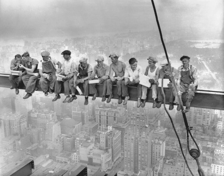 This famous photograph from 1932 depicts steelworkers eating lunch atop the 70-story RCA building while New York's thousands rush to crowded restaurants and congested lunch counters for their noon lunch below.