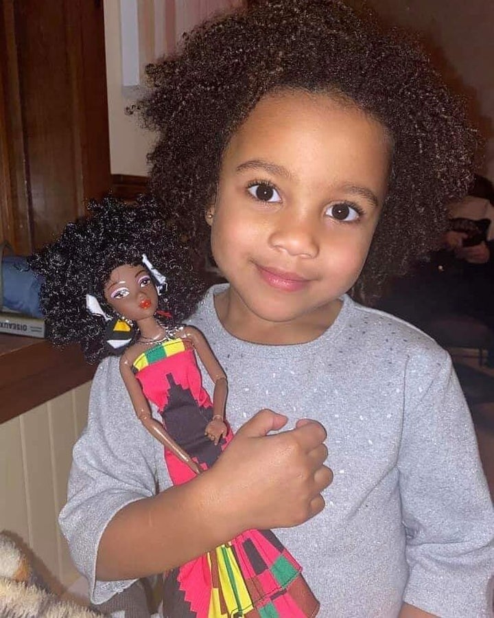 A little girl with her Ymma doll.