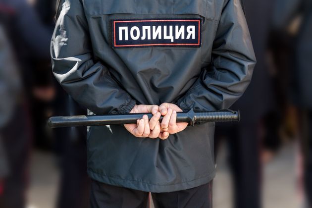 Russian policeman with police truncheon. Text in russian: Police