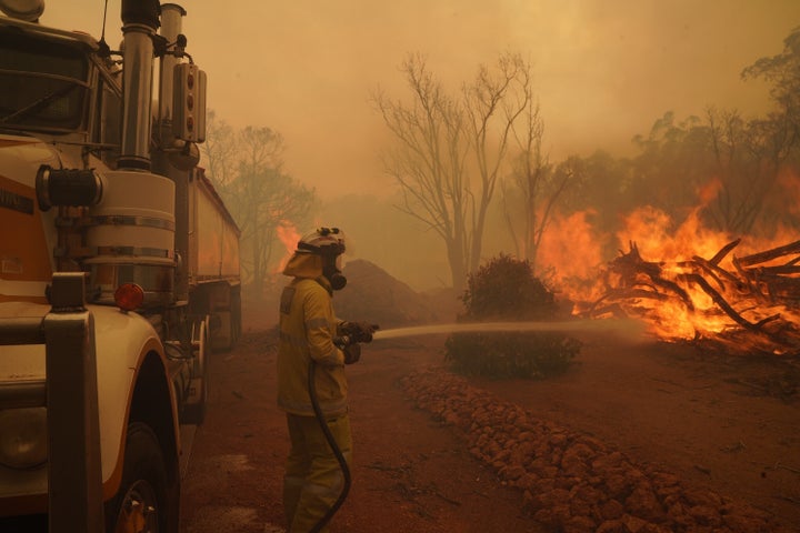 Firefighters attempt to contain a bushfire in Wooroloo on February 2 in Perth.